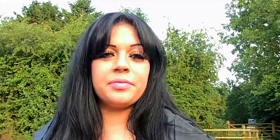 Fat brunette is kneeling in front of two guys, in the forest, and sucking their cocks
