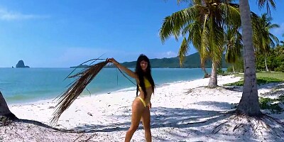 Micro bikini tease by sexy teen who walks on a beach