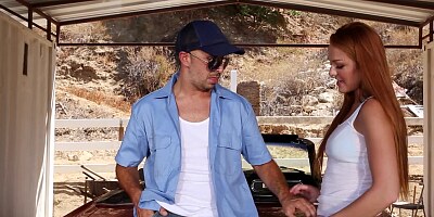 A redhead is on top of a car, getting her pussy ravaged deeply