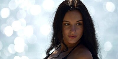 Cute-looking brunette Sasha C is showing off her naked pussy