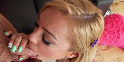 Blonde with a sexy smile is sitting down on a large hard cock