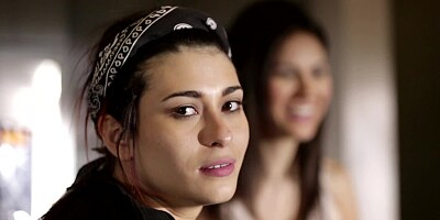 Two girls are licking and caressing one another in a hot manner