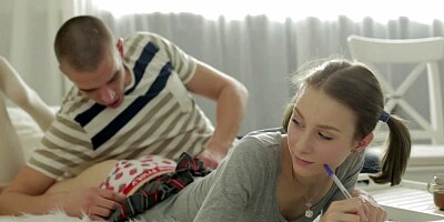 A brunette with pigtails is getting fucked on the bed hard