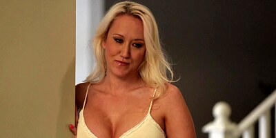 A blonde milf places her hands on a large cock to tug it nicely