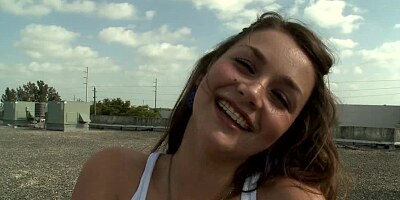 Brunette is naked on the roof, spreading her pussy lips to a guy