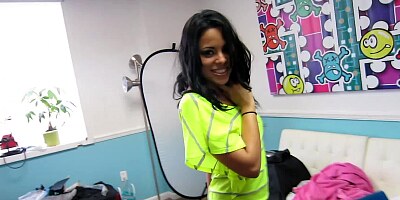 A Latina with an infectious smile is sucking a very large pole