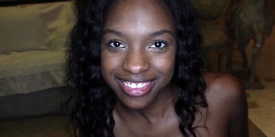 A black chick is kissing a large white dick close up to us