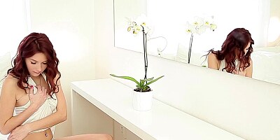 A redhead is naked and alone in front of the camera lens here