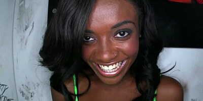 Black chick is teasing a large dick in a glory hole and she smiles