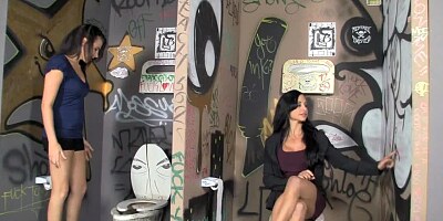 Dark haired ladies are sucking a cock through a glory hole