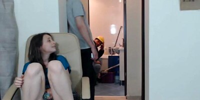 Teen Masturbates While Plumbers are Working Behind
