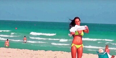 Sexy curves are seen on the beach in this scene