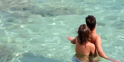 Nude babe caught jerking her BF's cock on the beach