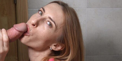 Pretty babe flirts with the camera while polishing hard cock