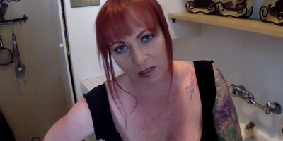 Redhead MILF flirts with the camera while sucking a hard dick