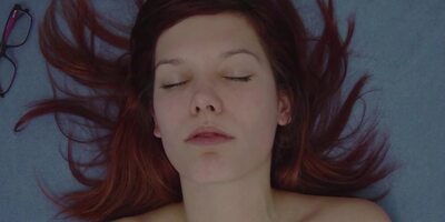 Redhead teen caresses her pussy solo