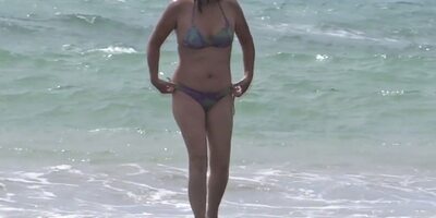 Hairy mature shows off on the beach while masturbating