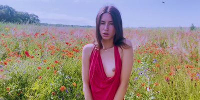 Slim Beauty Pleases Herself In A Flower Field