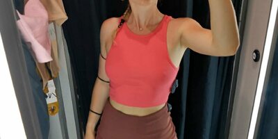 A girl with a perfect figure shows her breasts in a fitting