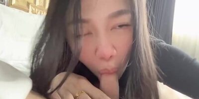 Japanese stunner is dressed in black nylons while her counterpart is munching and deep throating her toes