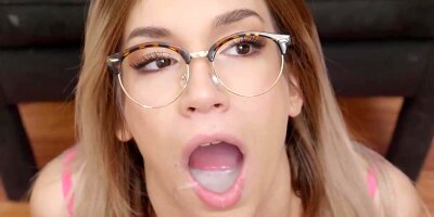 Adorable towheaded stunner with glasses, Megan Nicole is licking new spunk, in front of the camera