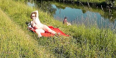 Wild Beach. Sexy Milf Platinum Naked Sunbathing On River Bank, Random Fisherman Guy Watches. Naked In Public. Nude Beach