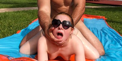 Ginger with sunglasses gets screwed doggystyle poolside