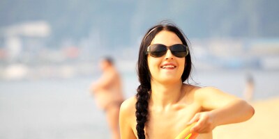 Young nudist with small tits and tattoos on her back shows her tight bottom