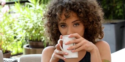 Curly-haired nymph seduces guy using her feet