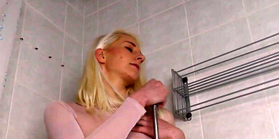 Stimulating her clitoris while getting wet in the shower
