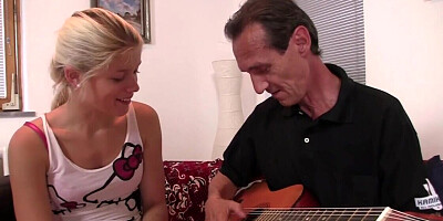 Skinny blonde woman is giving a BJ to an older man