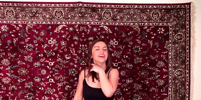 Brunette Nina Myers fucks her pussy against the background of the carpet