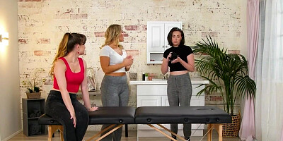 Female photographer is filming lesbians on the massage table