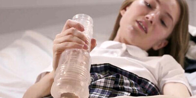 Cute college girl jerks her strapless dick until it squirts