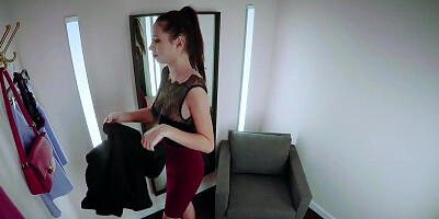 Petite Asian girl is trying on clothes in the fitting room