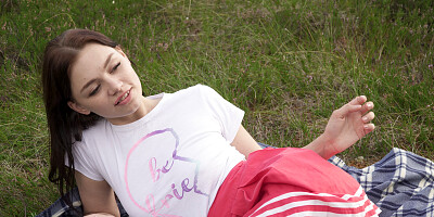 Gorgeous young redhead plays with herself at the forest's edge