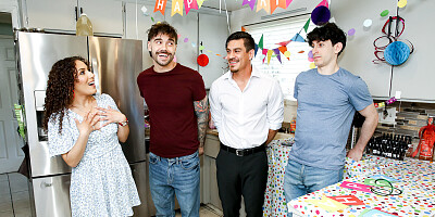 Three men are stuffing the holes of a short brunette