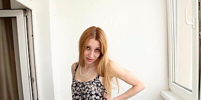 Blonde with a sexy smile showing off on the balcony