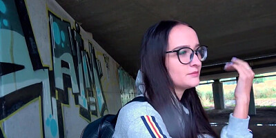 Glasses girl strokes that dick and takes it under the bridge