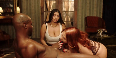 A b runette and a redhead are having sex in the room