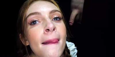 Blue - eyed blonde teen with braids is sucking cock through a gloryhole, while her partner is moaning